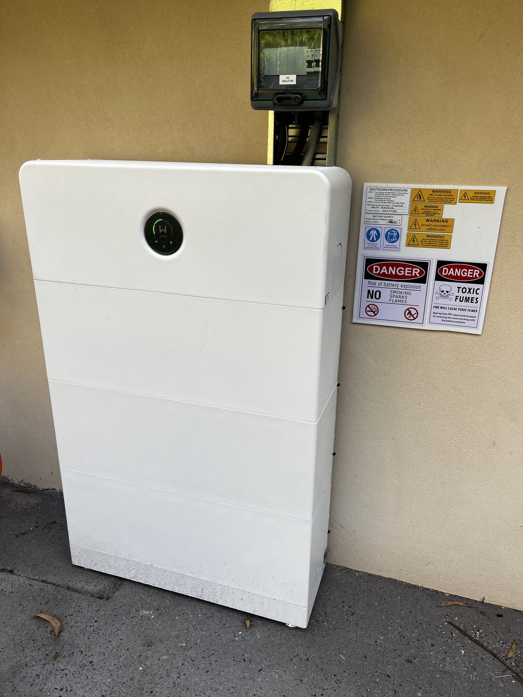 GoodWe home battery installed against an exterior wall beside the meter box