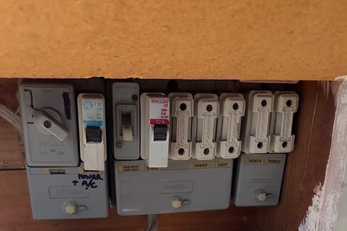 Old switchboard with ceramic rewireable fuses and no safety switches before replacement by SALTD Electrical
