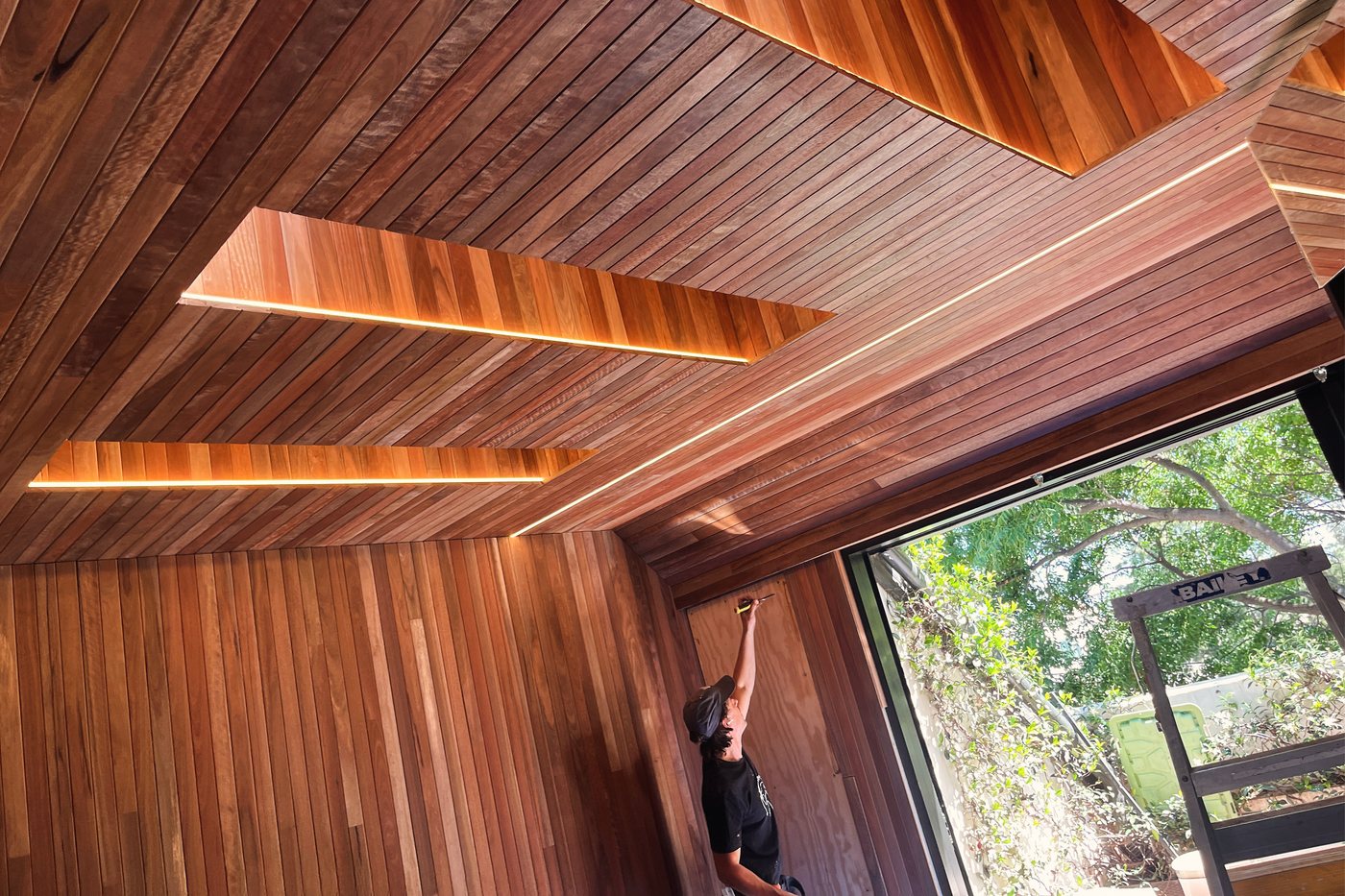 Concealed LED strip lighting in a raked timber ceiling, installed by SALTD Electrical